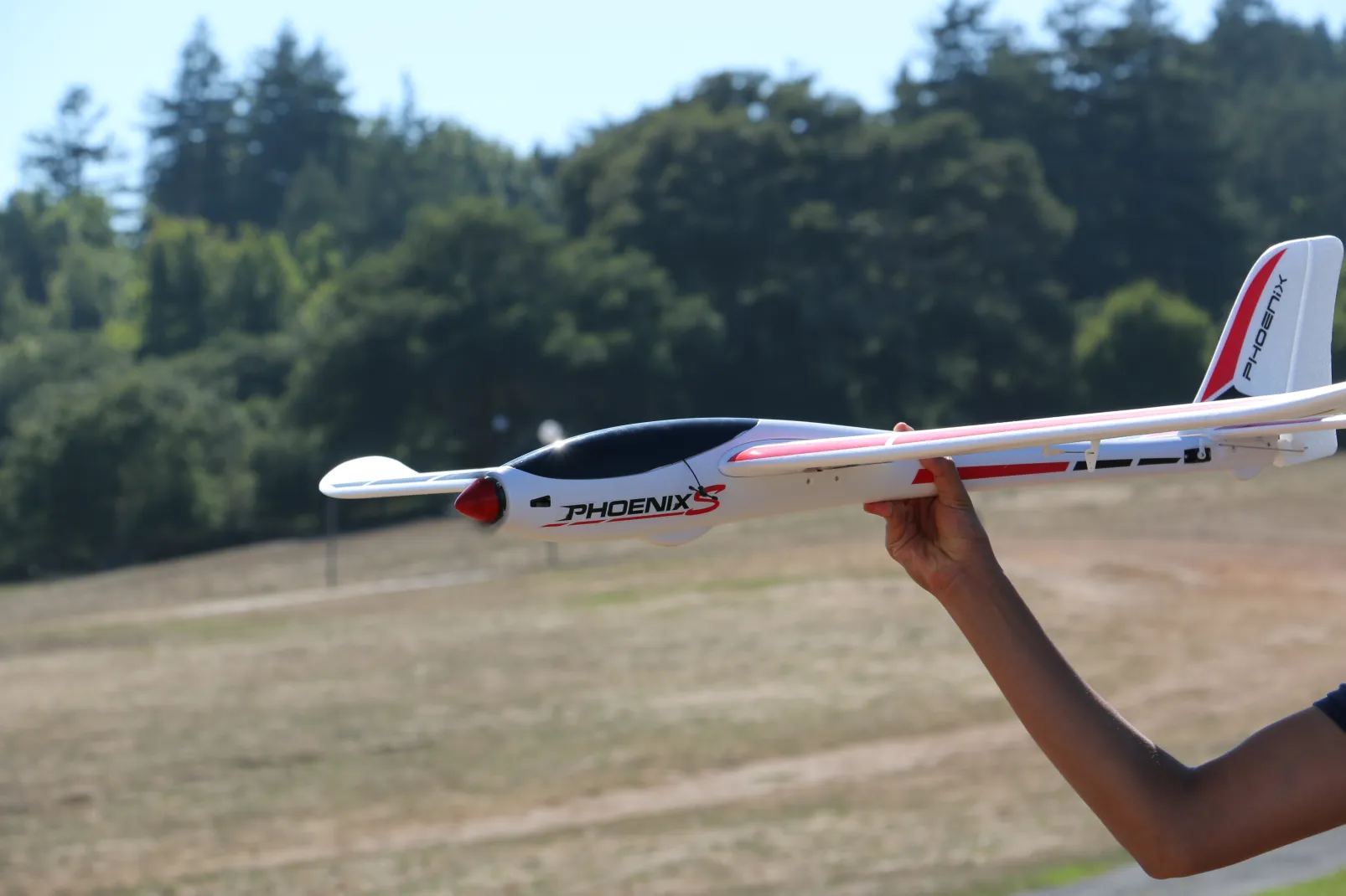 Hand-launching the Phoenix S glider over the meadow